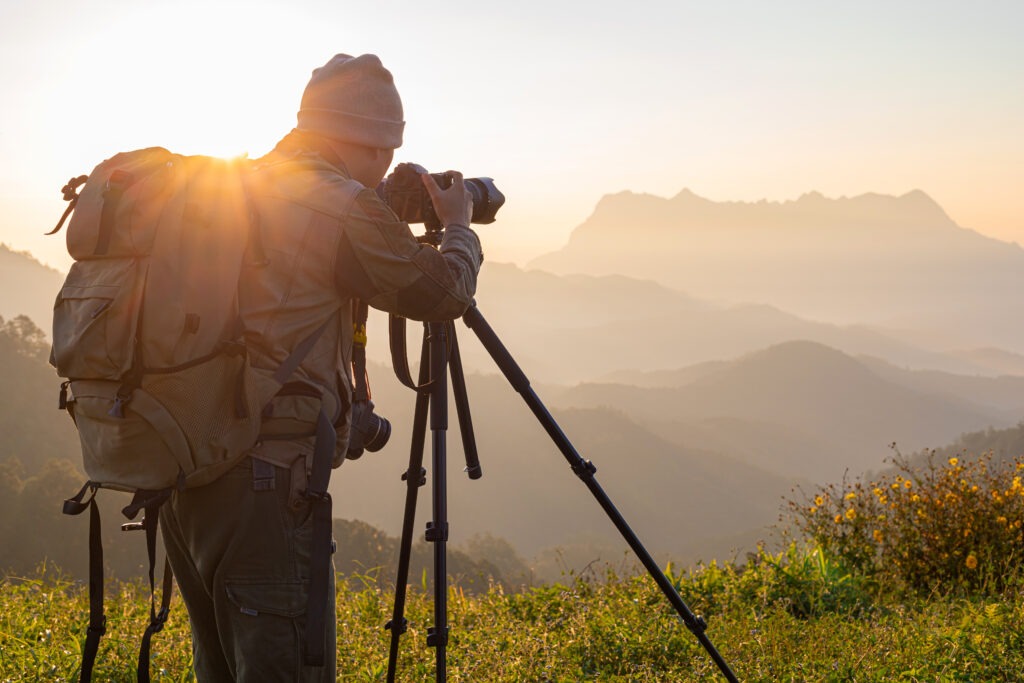 Nature photographer take photos with mirror camera on peak of mo